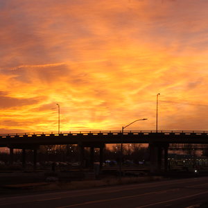 Sunset burns bright above an overpass