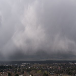 Silvery sheets of rain in a kind of triangle shape over town