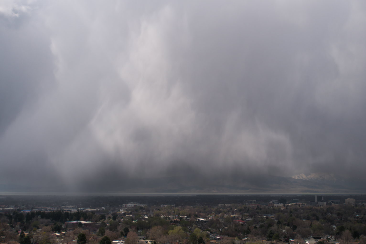 Silvery sheets of rain in a kind of triangle shape over town