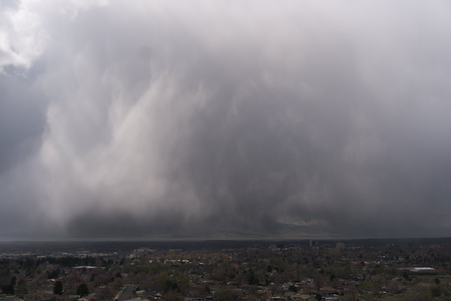 Silvery sheets of rain over town
