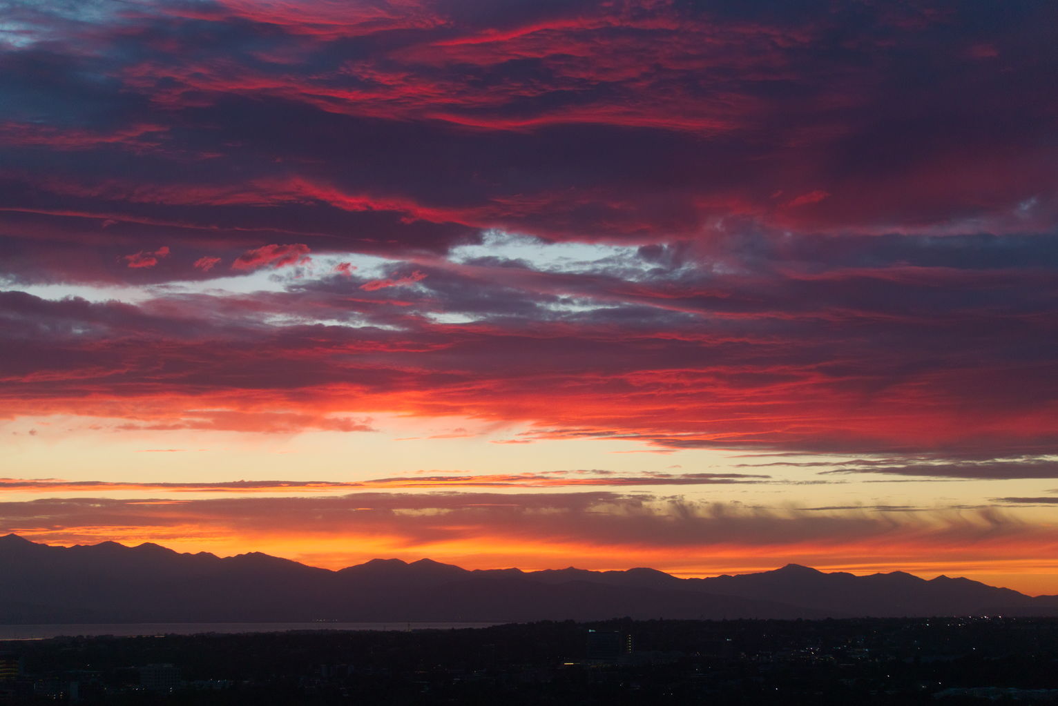 Late sunset lit clouds over the west mountains