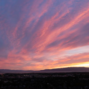 Sunset lit clouds stretch out over town and the mountains to the west